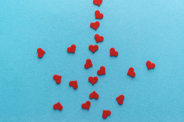 Valentine's day. Red hearts on a blue surface. Top view.