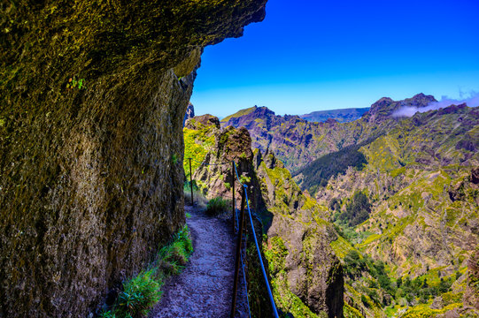 Beautiful hiking trail from Pico do Arieiro to Pico Ruivo, Madeira island. Footpath PR1 - Vereda do Areeiro. On summy summer day above the clouds. Portugal.