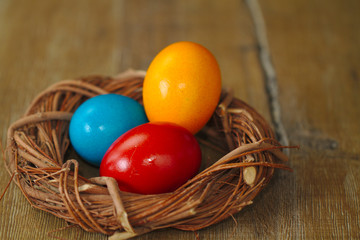 Small wicker nest with easter eggs