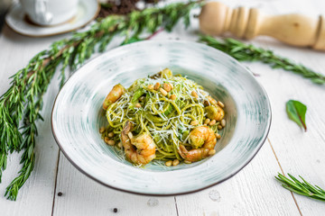 green pasta with shrimp top view. appetizing noodles with shrimp.