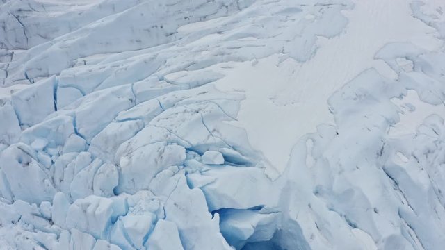 Norway glacier aerial top down shot of frozen blue glaciers puling up.