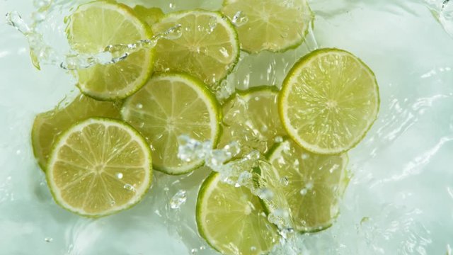 Super slow motion of falling lime slices into splashing water. Filmed on high speed cinema camera, 1000 fps.