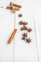 spices on a white wooden background. cinnamon and star anise on a white background