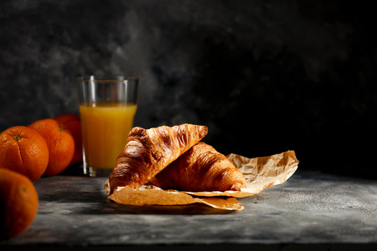Dark mood background and fresh croissants on board.Free space for your decoration and breakfast time. 