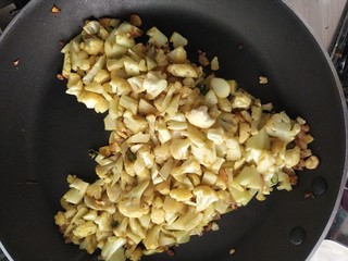 Frying chopped heart-shaped cauliflower