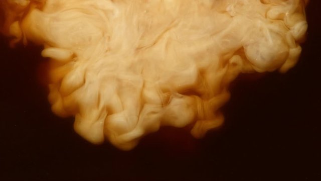 Super slow motion of pouring milk into coffee drink. Filmed on very high speed camera, 1000 fps.