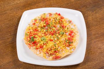 Masala Papad, roasted papads topped with onions, tomatoes and spices