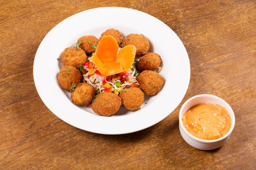 Cheese potato balls with cheese sauce
