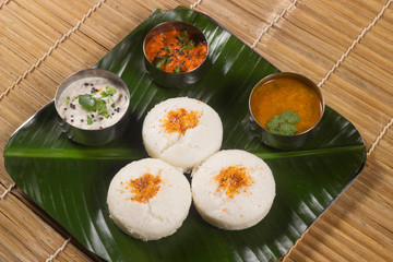 Idli with both sambar and coconut chutney. South Indian breakfast or snack dish