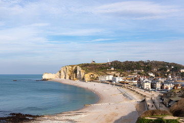 Fototapeta na wymiar Etretat, Normandy, France - The seafront and the beach at low tide, view to the north ('Amont' cliff)