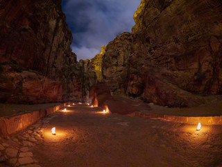 The Siq canyon in Petra during night walk, Jordan, Middle East