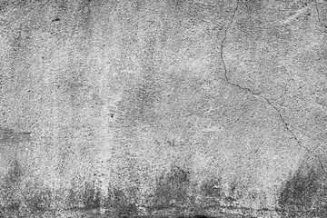 Texture of a concrete wall with cracks and scratches which can be used as a background