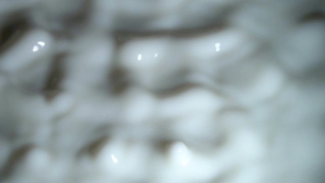 Slow Motion Video: Standing Wave on the surface of a viscous fluid when excited by vibration. Excitement of the surface of milk. Slowed down 16 times