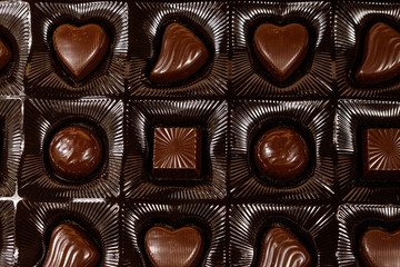 Assorted chocolate candies in a box. Close-up