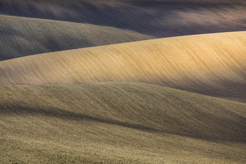 Beautiful colorful autumn landscape with curved fields in south moravia