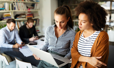 Programmers cooperating at IT company developing apps