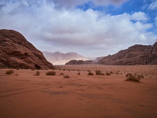 Beautiful Scenery Scenic Panoramic View Red Sand Desert and Ancient Sandstone Mountains Landscape in Wadi Rum, Jordan during a Sandstorm