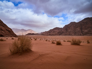 Fototapeta na wymiar Beautiful Scenery Scenic Panoramic View Red Sand Desert and Ancient Sandstone Mountains Landscape in Wadi Rum, Jordan