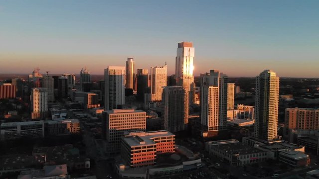 Aerial Drone shot of Downtown Austin, Texas. Shot from the West shooting east, coming from mopac revealing the south side of downtown. Shifting skyline reveals downtown construction and sunflares.