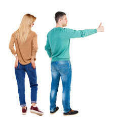 Back view of couple couple in sweater showing thumbs up.