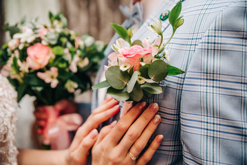 boutonniere of flowers on the groom's jacket on the wedding day