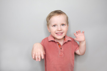 Portrait of happy joyful smiling baby boy; studio shot.