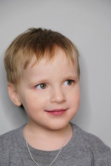 Portrait of beautiful smiling baby boy. Studio portrait isolated on grey background.Portrait of beautiful smiling baby boy. Studio portrait isolated on grey background.