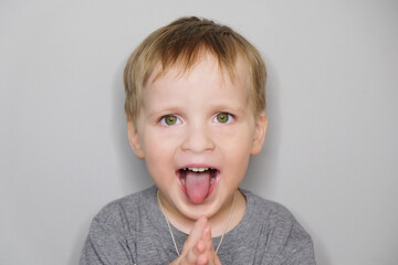 Close-up portrait of beautiful joyful baby boy; studio shot