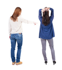 Back view of two pointing young girl in sweater.