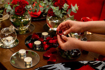 horizontal photo close-up of female hands decorating a dinner table for a festive dinner