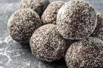 Homemade healthy protein energy balls with dried apricots, raisins, walnuts, almonds and coconut. Healthy sweet food.