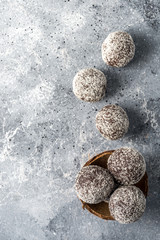 Homemade healthy protein energy balls with dried apricots, raisins, walnuts, almonds and coconut. Healthy sweet food.