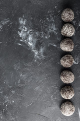 Homemade healthy protein energy balls with dried apricots, raisins, walnuts, almonds and coconut. Healthy sweet food.