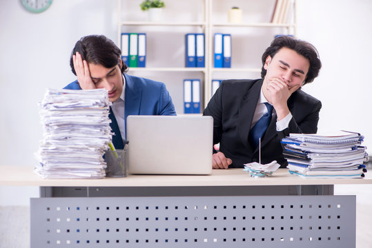 Two male colleagues unhappy with excessive work