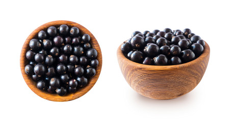 Black berries on white. Blackcurrants in a wooden bowl isolated on white background. Blackcurrant isolate. Blackcurrants isolated on white background. Top view. Berries from different angles on white.