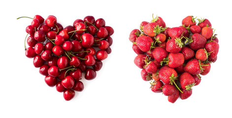 Heart shape red cherries and strawberries on white background. Background made of cherry and strawberry. Sweet fruits isolated on white background cutout.Ripe cherries hill isolated on white.Top view.
