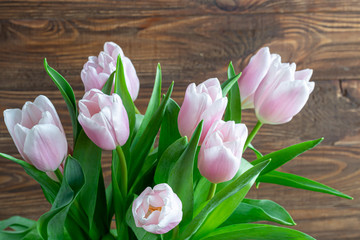 Bouquet of pink tulips for the holidays. Women's Day, Valentine's Day, name day. On a wooden background.