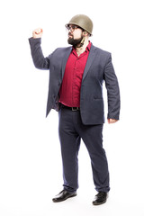 A man with a beard in a military helmet and in a strict suit. White background. Vertical.