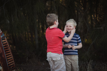 Young brothers showing affection in moody outdoor setting