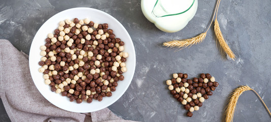 Wholegrain chocolate, milk balls and milk. Healthy cereal breakfast. Baby breakfast. Baby eating. Balanced diet. The top view