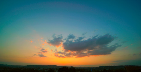 Fototapeta na wymiar Beautiful sunset sky above clouds with dramatic light.