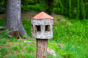 Wooden nest box for birds made with a tree trunk in Zamecky Park, in Hluboka Castle, Hluboka nad Vltavou, Czech Republic