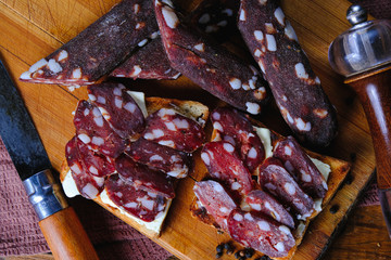 dried pork sausages composition on a wooden background