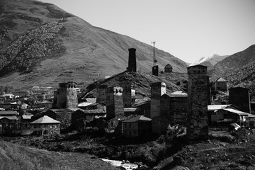 View of the village of Ushguli in a beautiful autumn landscape with white clouds in Svaneti. Georgia. Toned