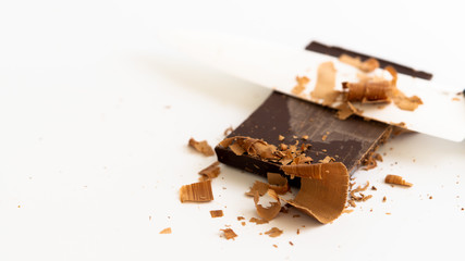 Chocolate bar chopped with knife. Knife is near it. 