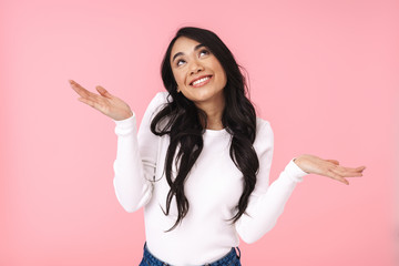 Image of young asian woman smiling and looking upward at copyspace