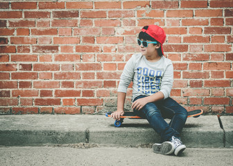 child with skateboard and sunglasses