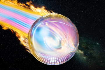 A studio shot of a glass ball with strips of light that looks like a comet pulling a trail of light and fire behind it. In the background a starry sky with the Milky Way.