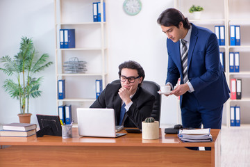 Boss and his male assistant working in the office