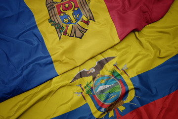 waving colorful flag of ecuador and national flag of moldova.